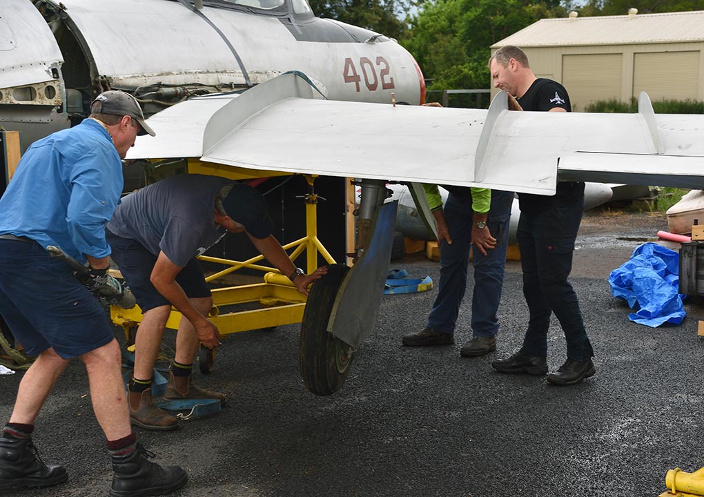 Hunter Fighter Collection volunteers re-attaching wings on MiG-17F at Scone NSW