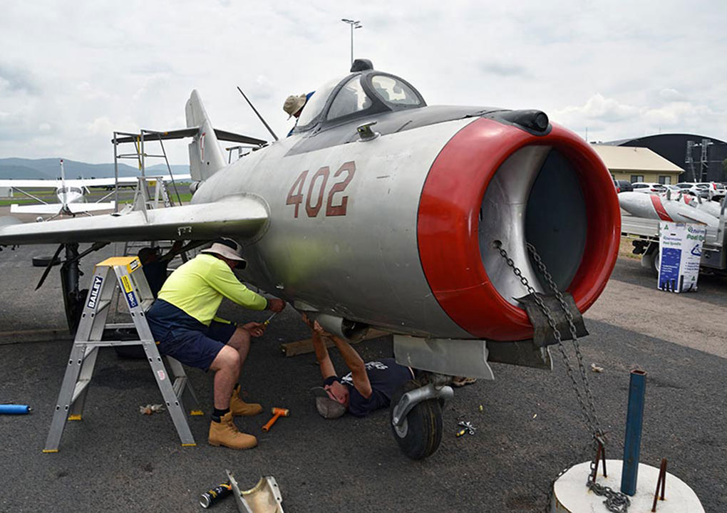 Hunter Fighter Collection volunteers refitting gun bay panels on MiG-17F at Scone NSW