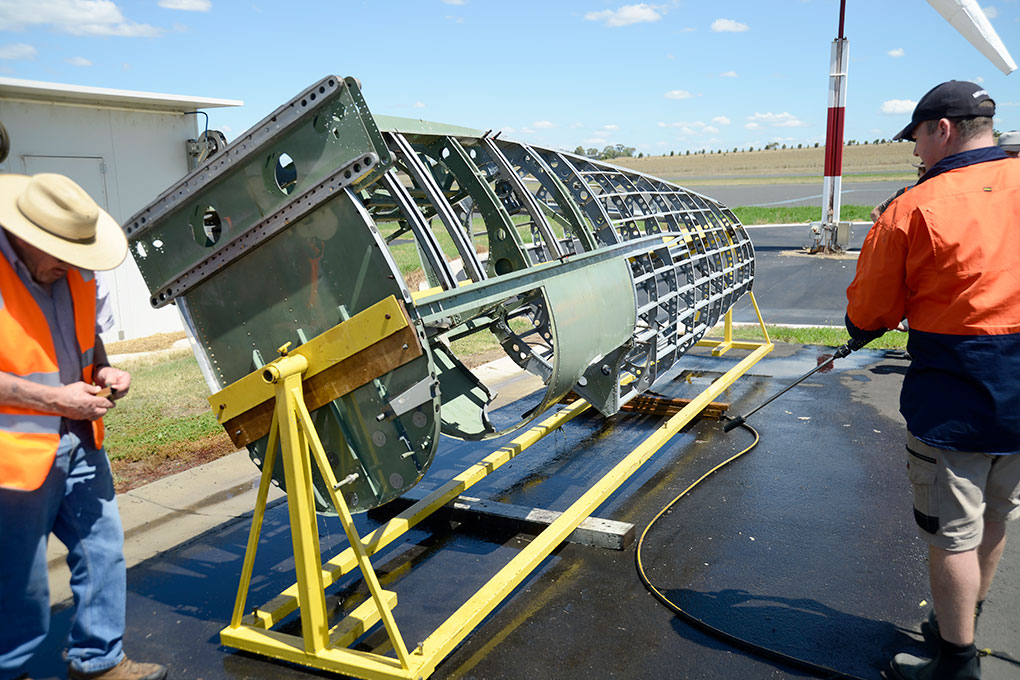 HFC volunteer Technical Team members clean the Spitfire fuselage upon arrival at Scone NSW from Toowoomba Qld